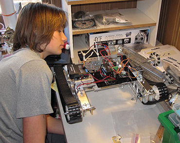 Misha working on Tetrix Robots before college.